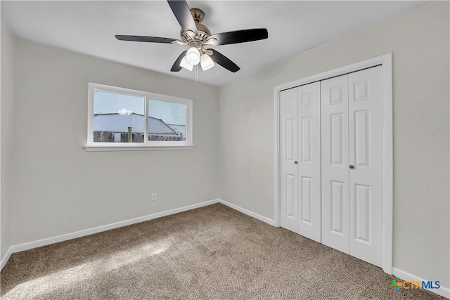 unfurnished bedroom featuring carpet floors, ceiling fan, and a closet