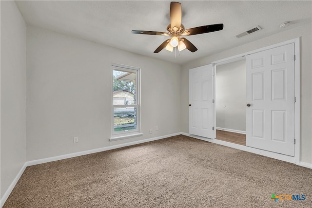 unfurnished bedroom featuring carpet and ceiling fan