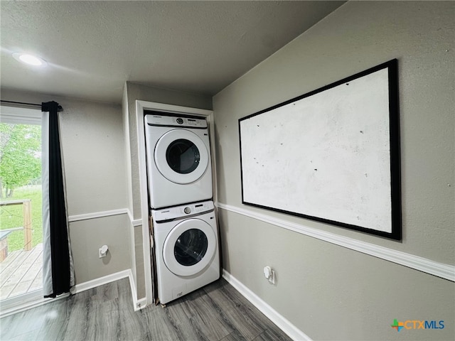 706 Golf Course Rd, Gatesville, TX 76528 - washroom with laundry area, wood finished floors, baseboards, stacked washing maching and dryer, and a textured ceiling