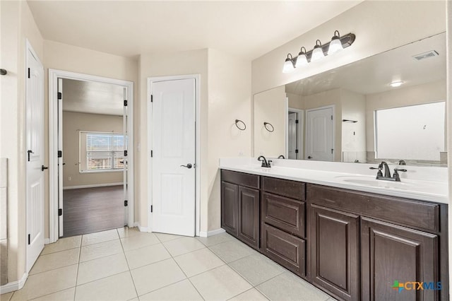 bathroom with tile patterned floors and vanity