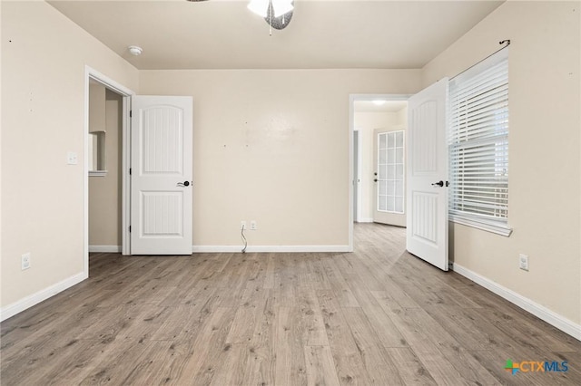 empty room featuring ceiling fan and light wood-type flooring