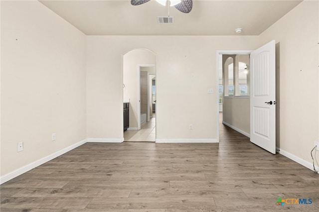 empty room featuring ceiling fan and light wood-type flooring