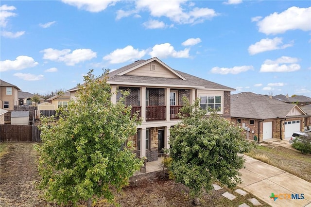 view of front of house with a garage and a balcony