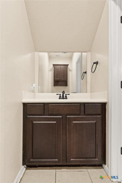 bathroom with tile patterned flooring and vanity