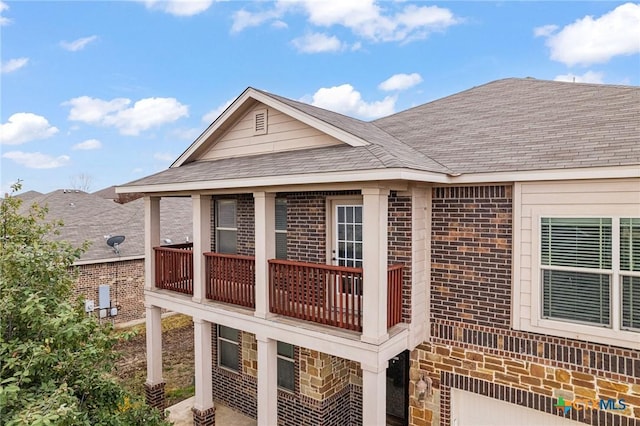 view of side of property with a balcony and a garage