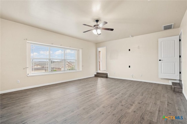 unfurnished living room featuring hardwood / wood-style floors and ceiling fan