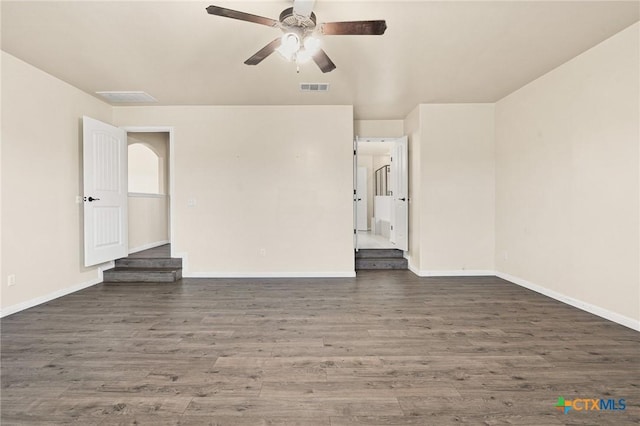 unfurnished room featuring ceiling fan and dark wood-type flooring