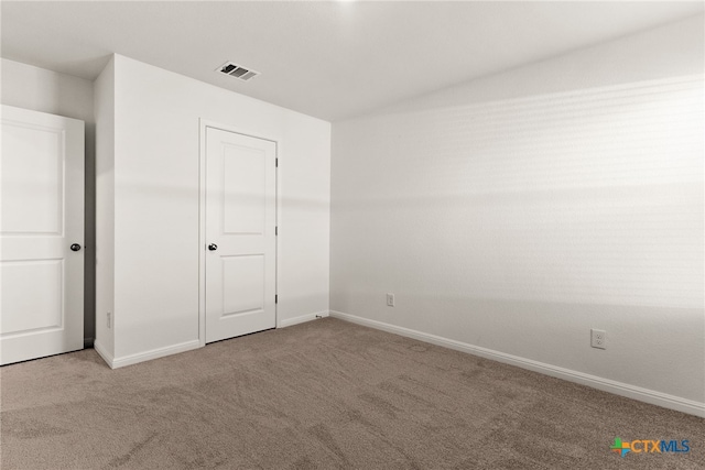 unfurnished bedroom featuring a closet and carpet flooring