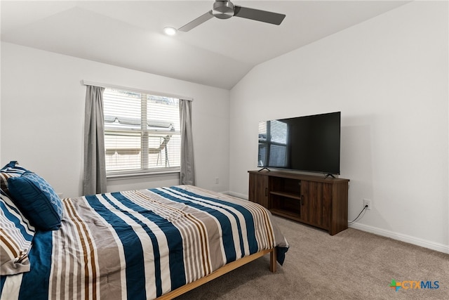 bedroom with vaulted ceiling, light carpet, and ceiling fan