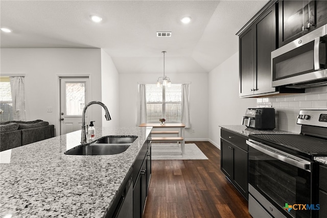 kitchen featuring appliances with stainless steel finishes, sink, decorative light fixtures, and plenty of natural light