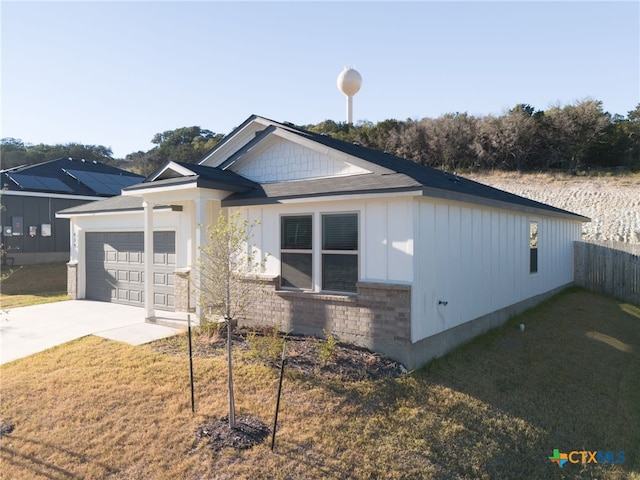 view of front of house with a garage and a front yard