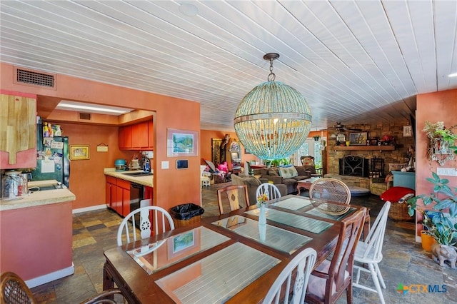 4842 W Fm 2147, Horseshoe Bay, TX 78657 - dining room with a fireplace, wooden ceiling, and a chandelier