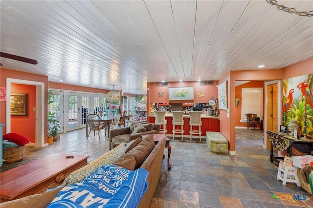 4842 W Fm 2147, Horseshoe Bay, TX 78657 - living room with wood ceiling, stone finish flooring, french doors, and a ceiling fan