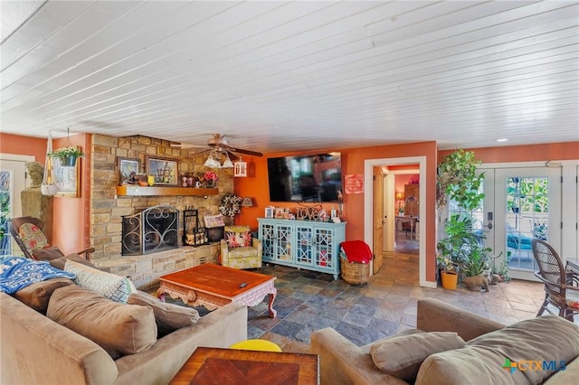 4842 W Fm 2147, Horseshoe Bay, TX 78657 - living area featuring stone tile floors, ceiling fan, a stone fireplace, and french doors