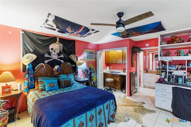 4842 W Fm 2147, Horseshoe Bay, TX 78657 - bedroom with light tile patterned floors, connected bathroom, an AC wall unit, and a ceiling fan