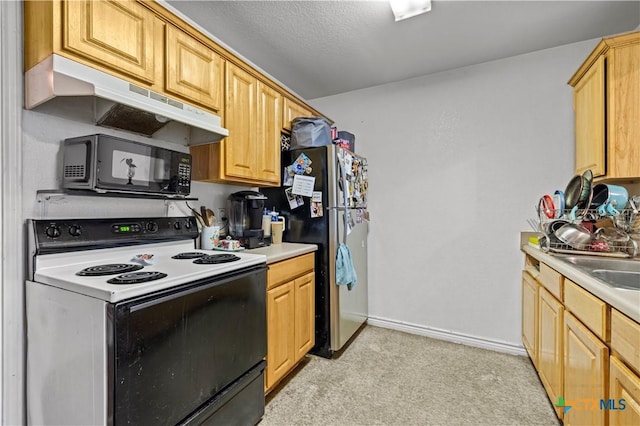 1104 S Terrace St, Temple, TX 76501 - kitchen featuring electric range, black microwave, under cabinet range hood, freestanding refrigerator, and light colored carpet
