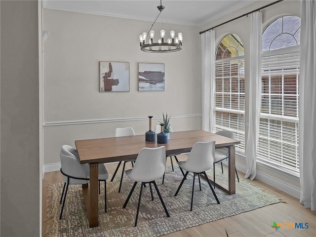13217 Armaga Springs Rd, Austin, TX 78727 - dining space featuring a chandelier, light wood finished floors, baseboards, and ornamental molding
