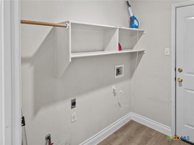 13217 Armaga Springs Rd, Austin, TX 78727 - washroom with hookup for a washing machine, wood finished floors, baseboards, electric dryer hookup, and gas dryer hookup