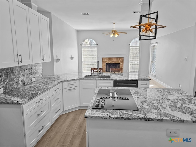 13217 Armaga Springs Rd, Austin, TX 78727 - kitchen featuring a ceiling fan, a sink, and white cabinetry
