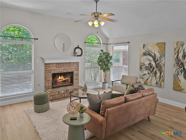13217 Armaga Springs Rd, Austin, TX 78727 - living room with ceiling fan, wood finished floors, a brick fireplace, lofted ceiling, and baseboards
