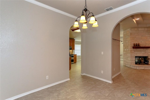 unfurnished dining area with arched walkways, visible vents, ornamental molding, a stone fireplace, and baseboards