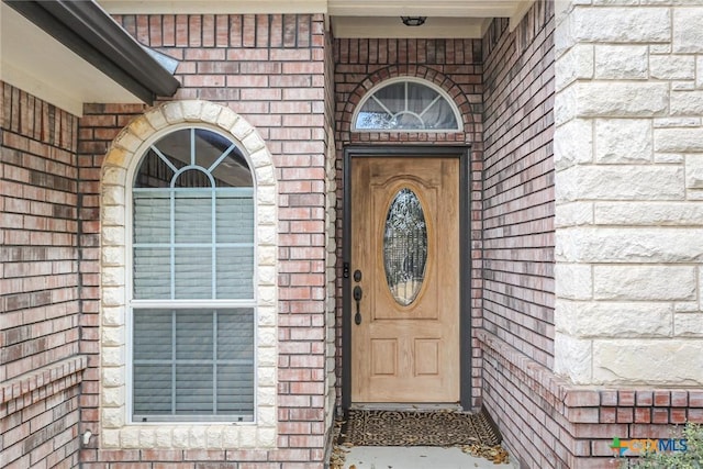 property entrance with brick siding