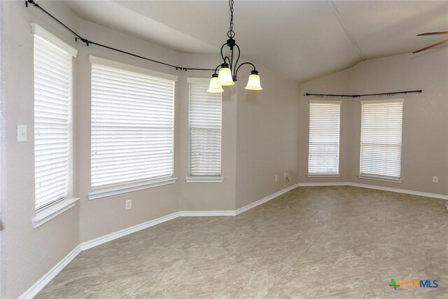 empty room with lofted ceiling, ceiling fan with notable chandelier, baseboards, and a healthy amount of sunlight