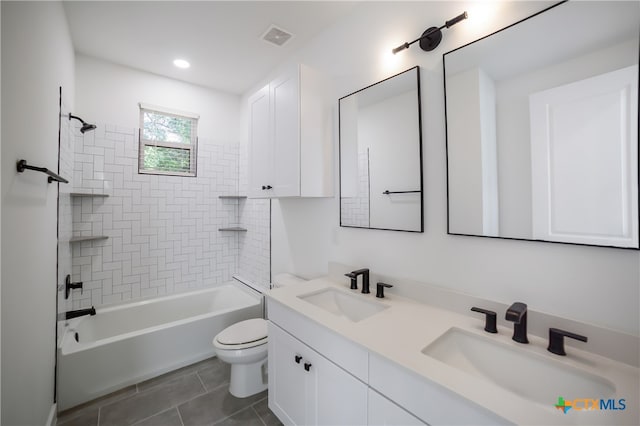 full bathroom with tiled shower / bath, tile patterned floors, toilet, and vanity