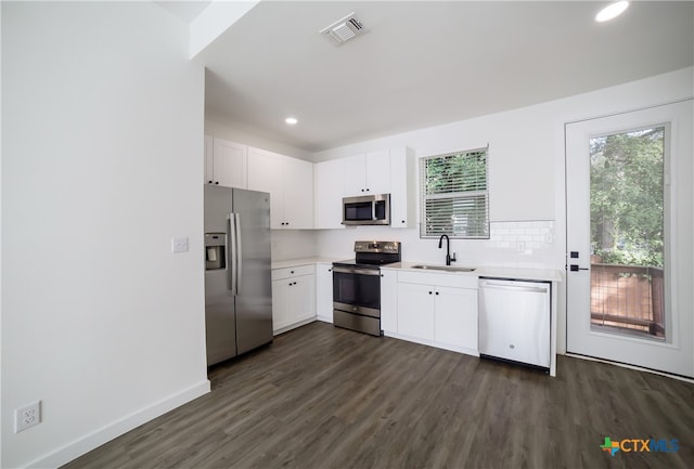 kitchen featuring white cabinetry, appliances with stainless steel finishes, sink, and dark hardwood / wood-style flooring