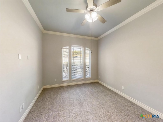 carpeted spare room featuring ornamental molding and ceiling fan