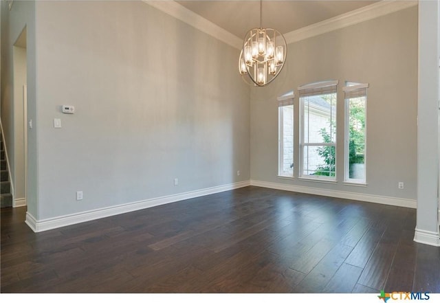 empty room with dark hardwood / wood-style flooring, crown molding, and a chandelier