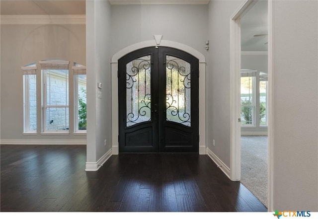 entryway featuring french doors, crown molding, and dark hardwood / wood-style floors