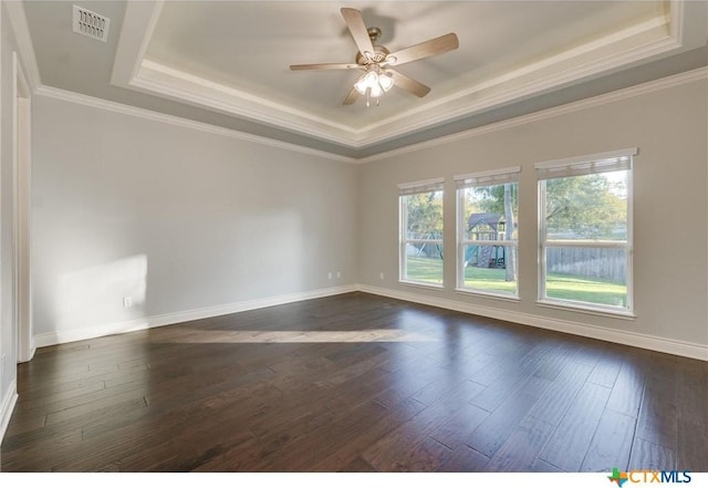 spare room with ceiling fan, crown molding, dark hardwood / wood-style floors, and a tray ceiling