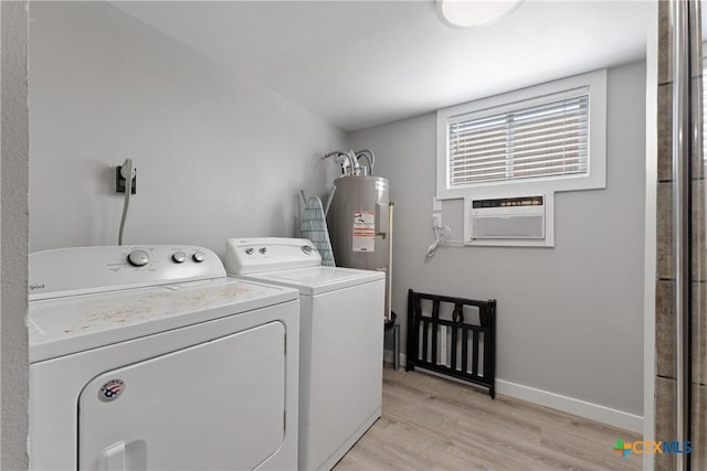 1113 W Port Dr, Port Mansfield, TX 78598 - washroom featuring washer and clothes dryer, light wood-type flooring, water heater, and cooling unit
