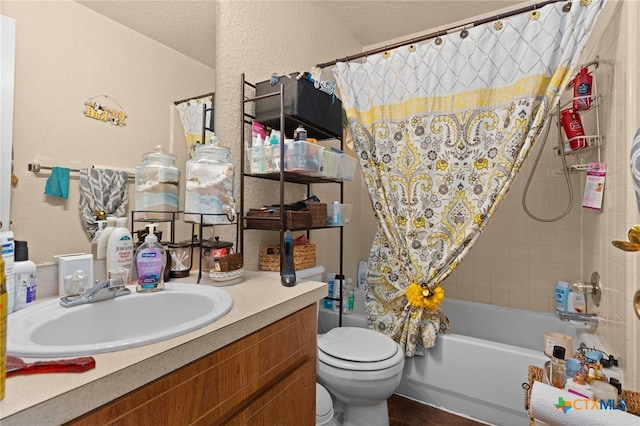 4509 Mattie Dr Unit A-D, Killeen, TX 76549 - bathroom featuring toilet, vanity, shower / tub combo with curtain, a textured wall, and wood finished floors