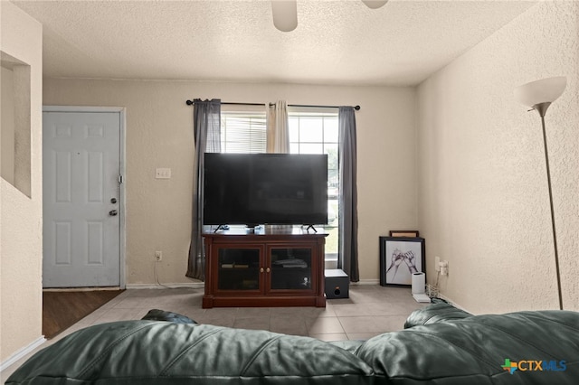 4509 Mattie Dr Unit A-D, Killeen, TX 76549 - living room featuring ceiling fan, a textured wall, a textured ceiling, and tile patterned floors