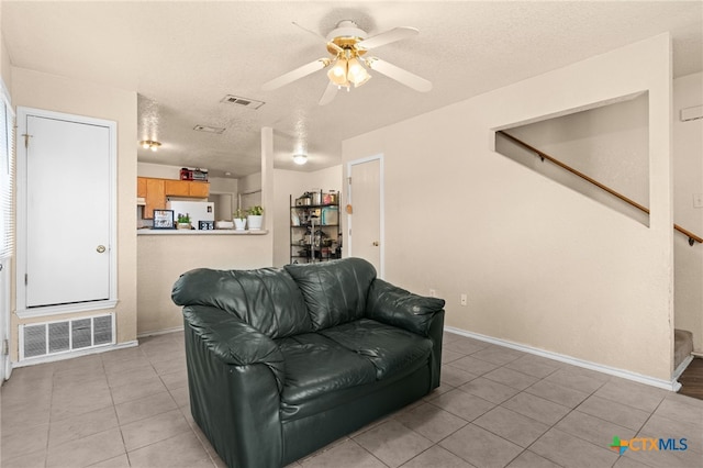 4509 Mattie Dr Unit A-D, Killeen, TX 76549 - living room with light tile patterned floors, ceiling fan, baseboards, a textured ceiling, and stairway