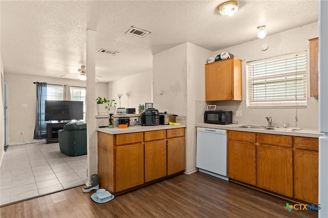 4509 Mattie Dr Unit A-D, Killeen, TX 76549 - kitchen with white dishwasher, a sink, black microwave, light countertops, and a textured ceiling