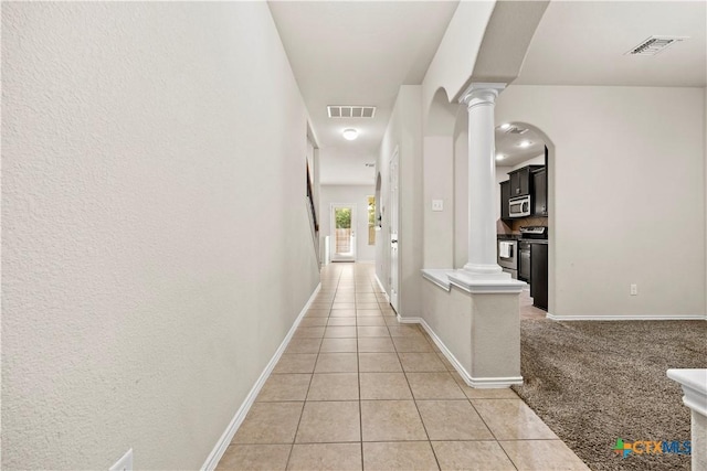 703 Curtis Dr, Killeen, TX 76542 - corridor featuring decorative columns, light tile patterned floors, and arched walkways