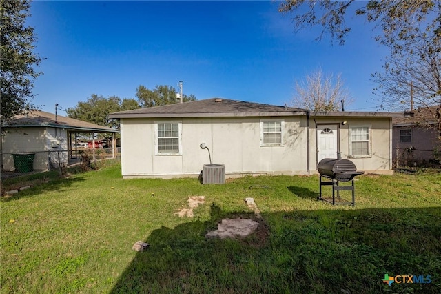 rear view of house featuring a yard