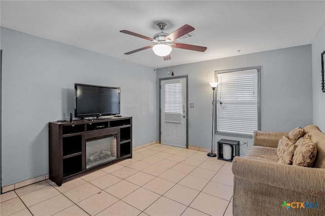 tiled living room featuring ceiling fan