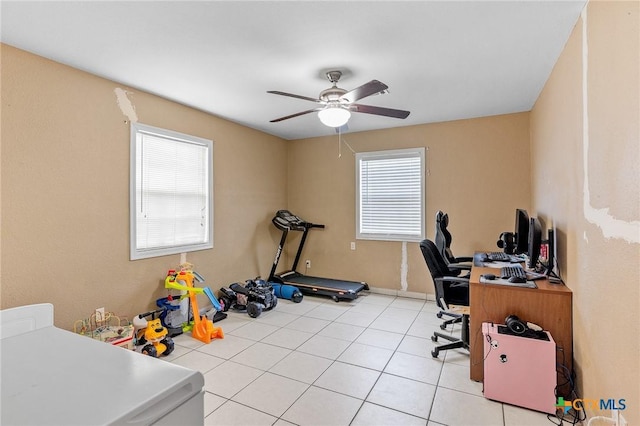 office area with light tile patterned floors and ceiling fan