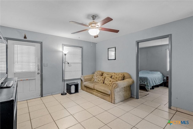 tiled living room with ceiling fan