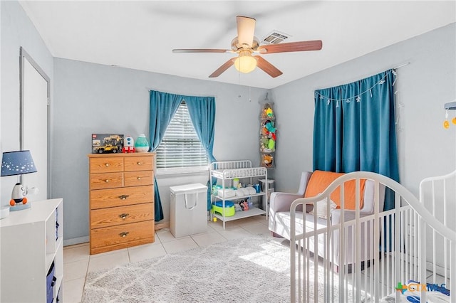 bedroom with ceiling fan and light tile patterned floors