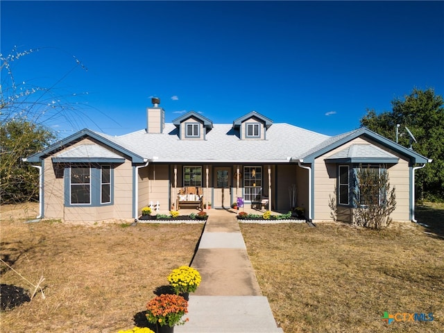 view of front of property with a porch and a front lawn