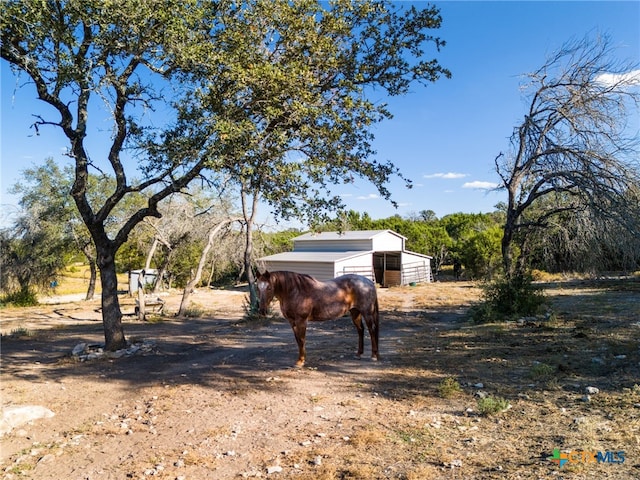 exterior space with a rural view and an outbuilding