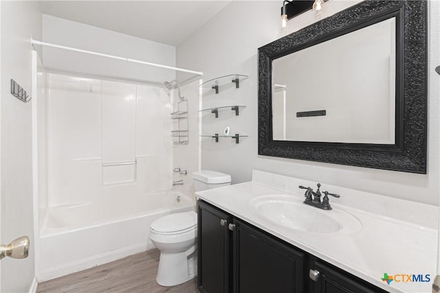 full bath with shower / bathtub combination, vanity, toilet, and wood finished floors