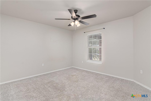 spare room featuring carpet floors, ceiling fan, and baseboards