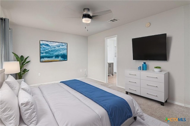 bedroom with baseboards, visible vents, ceiling fan, and light colored carpet