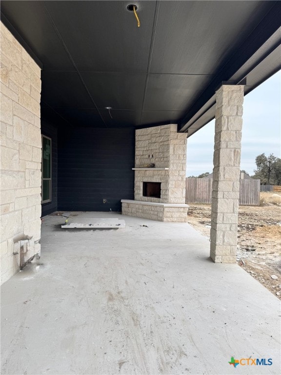 view of patio / terrace featuring an outdoor stone fireplace